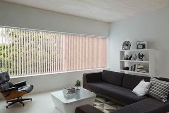 Orange vertical blinds in bright white living room