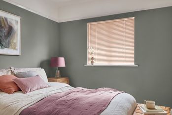 Orange venetian bedroom blind in white bedroom