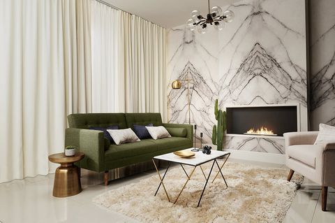 Cosy Living Room with a fire and windows framed with plain ivory curtains