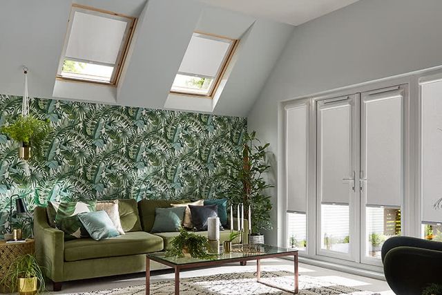 Living room with sofa, coffee table and Acacia Silver bloc blinds on a Velux window