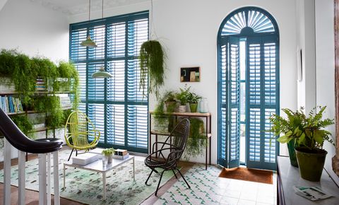 Blue custom colour shaped shutters in hallway 