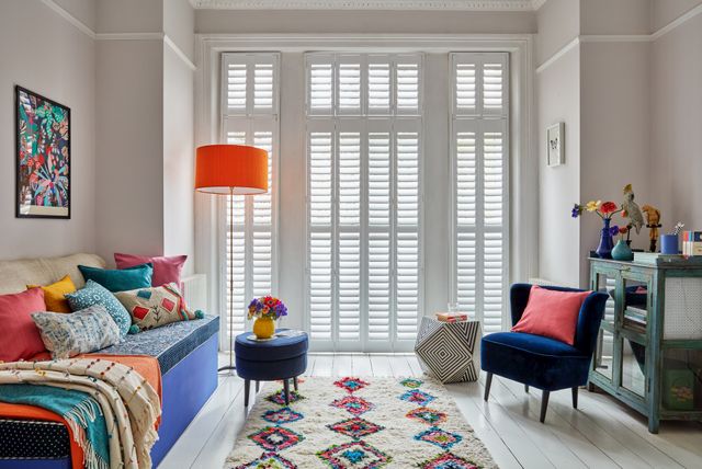 Living room with full height shutters at french doors