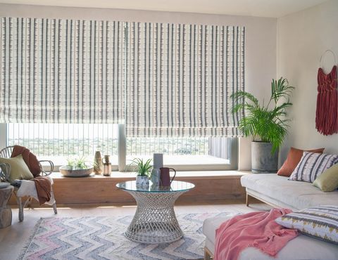 Living room with stripey Roman blind on sliding doors