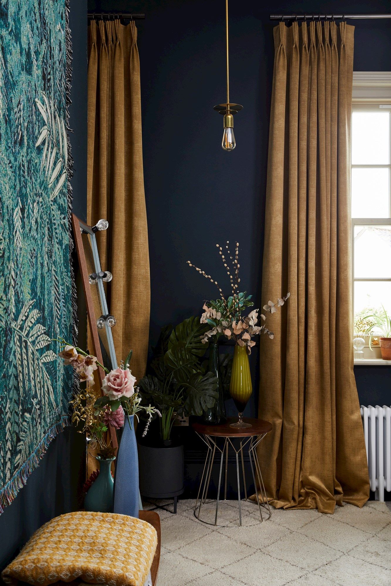 Close up shot of bedroom window with gold velvet curtains 