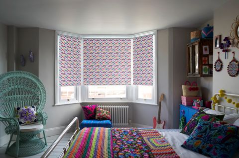Jazz Fuchsia roller blind in a bedroom bay window