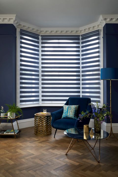 Denim Blue Day and Night blind in a living room bay window