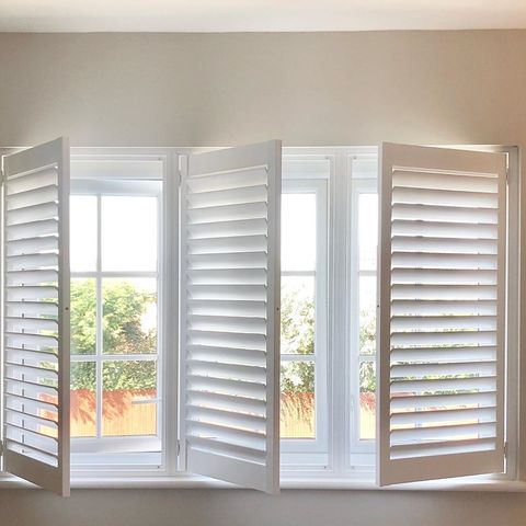 close up of window dressed with shutters