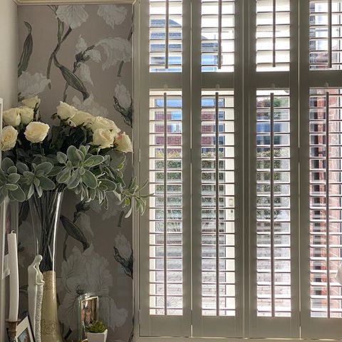 Limed white full height shutters in living room
