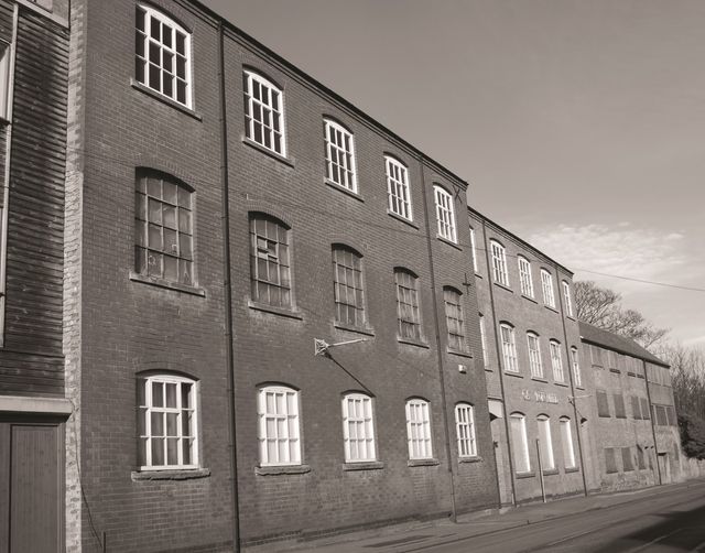 an old black and white image of the Carlton Mill on Burton Road in Nottingham