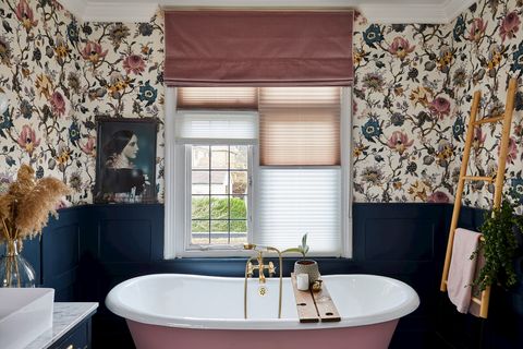 Rose pink, velvet roman blind over light, pleated blinds in a floral bathroom with rose pink and navy accents