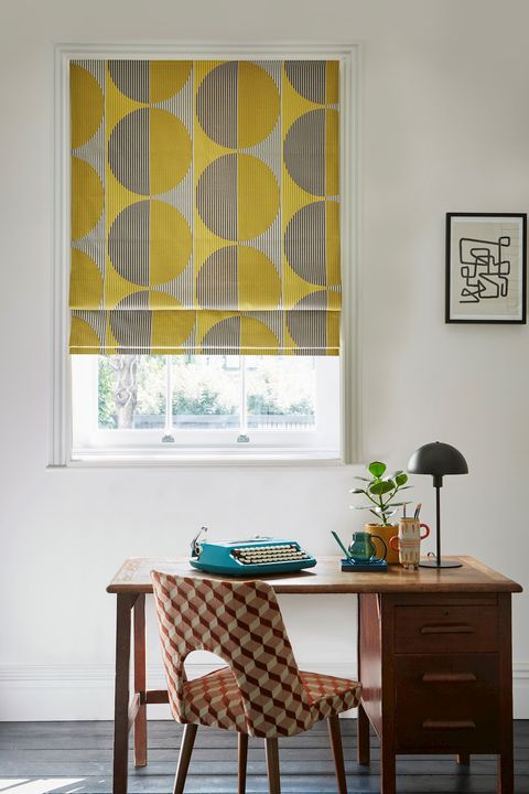 Stella Mustard Roman blind fitted to a small window in a white decorated study room