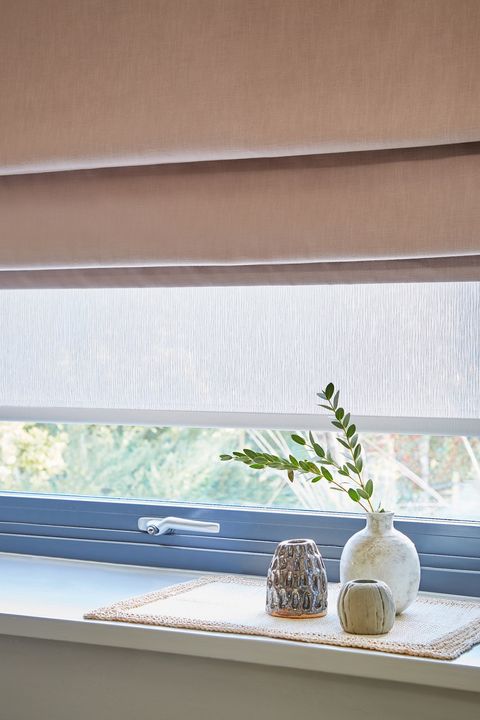 Serene Mauve roman blind accompanied by a Solace Sheer roman blind 
