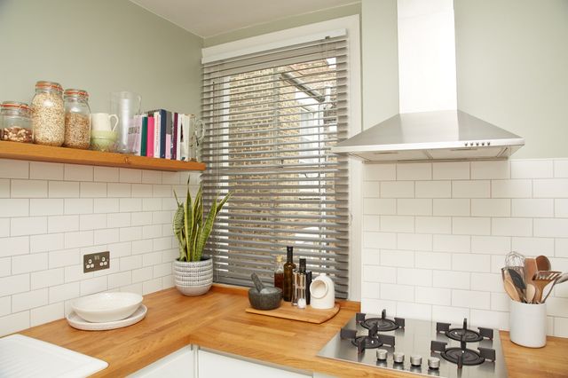 Mid grey metal venetian blinds in kitchen