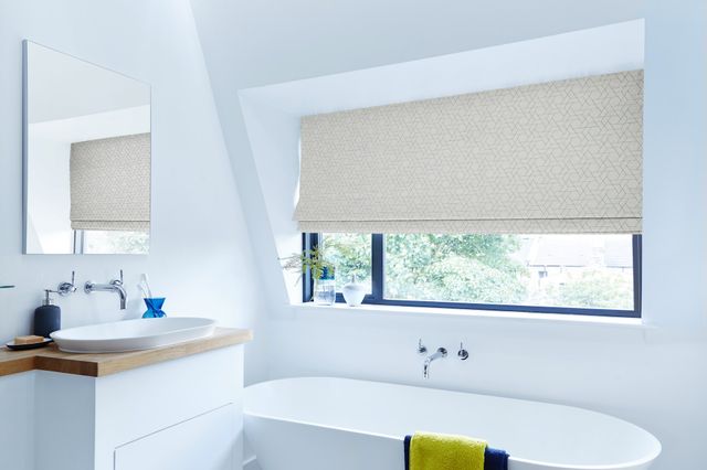 Jive blue patterned roman blind in bathroom