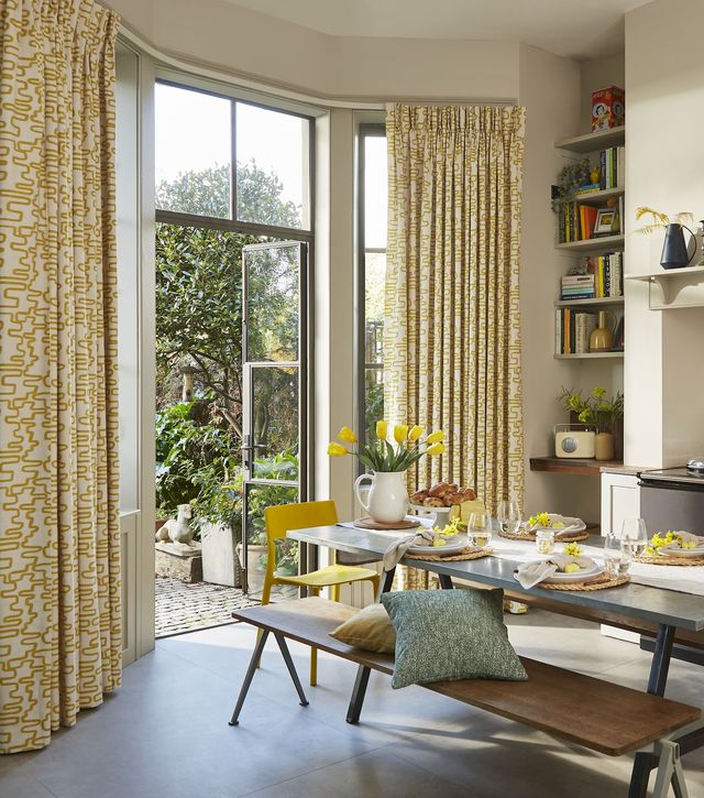 Wirl chartreuse yellow patterned curtains on bay window patio doors in kitchen/dining area