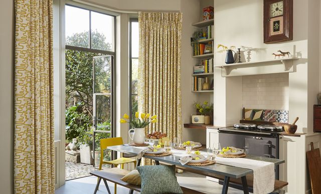 Wirl chartreuse yellow patterned curtains on bay window patio doors in kitchen/dining area