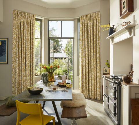 Wirl chartreuse yellow patterned curtains on bay window patio doors in kitchen/dining area