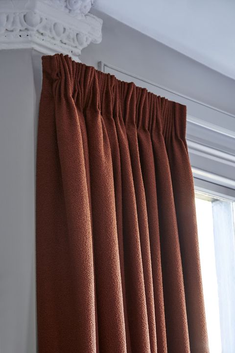Two pairs of soho boucle spice pinch pleat curtains in bay window in living room