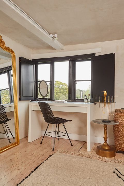 solid black shutters on windows above desk in bedroom