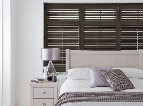 rustic black dalston wooden shutter on window above bed