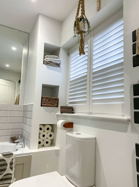 pure white full height shutters on small window in bathroom 