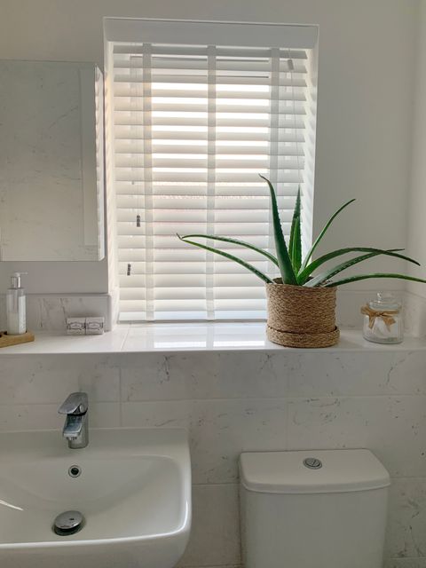 ellwood pearl white faux wood venetian blinds on small window in bathroom