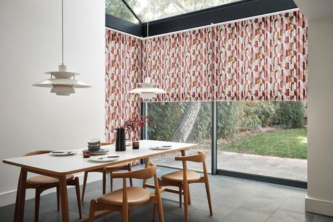 Bauhaus Mauve roller blinds on expansive patio door in open spaced living room