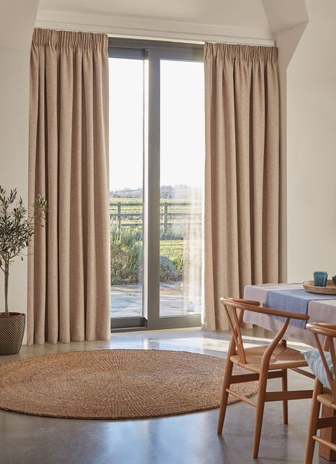nest almond floor length pencil pleat curtains on sliding patio doors in living room with matching decor