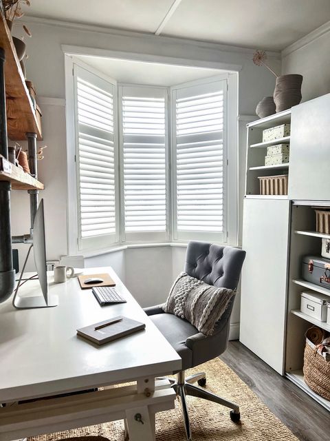 full height shutters on bay window in home office