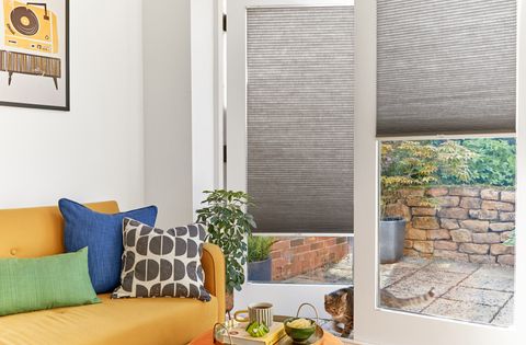 grey duette pleated blinds on large windows in open dining space