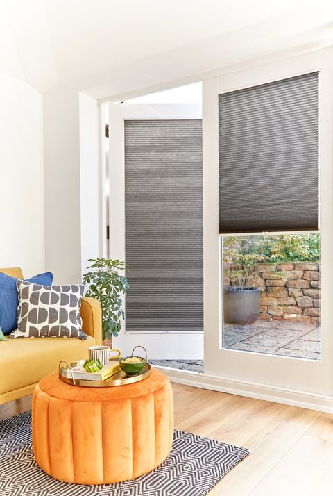  grey duette pleated blinds on large windows in open dining space