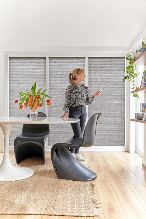  grey duette pleated blinds on large windows in open dining space