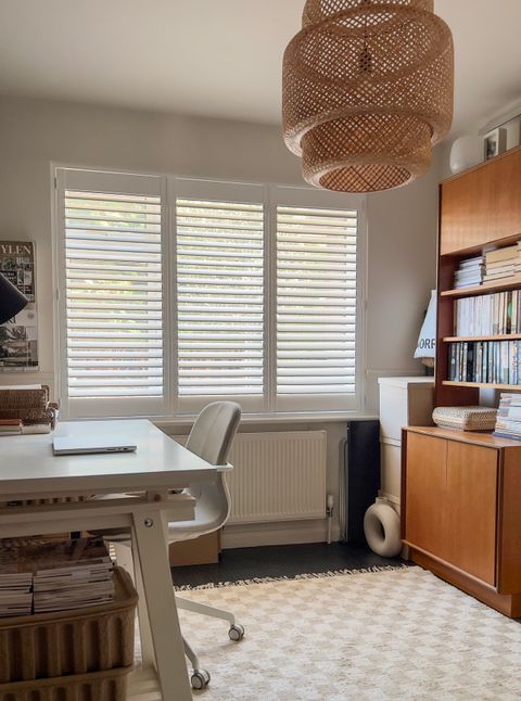 white shutters on large window in home office