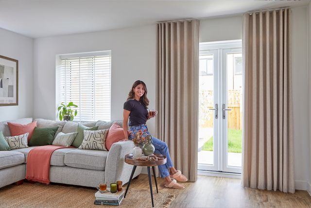 maisie almond floor length curtains on patio doors in living room with grey sofa