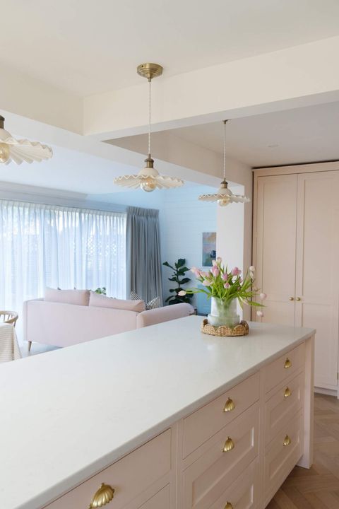 White-linen-curtains-hanging-in-a-sunlit-room-gently-swaying-in-the-breeze