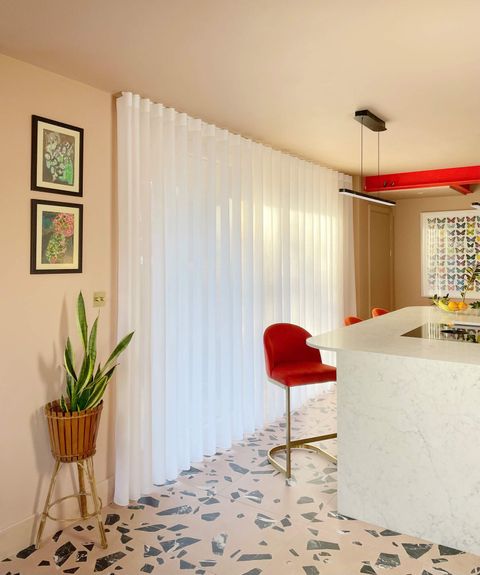 Kitchen-with-pink-pendant-light-table-white-voile-curtains