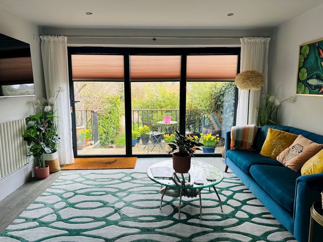 Stylish summer themed living room with large bifold doors